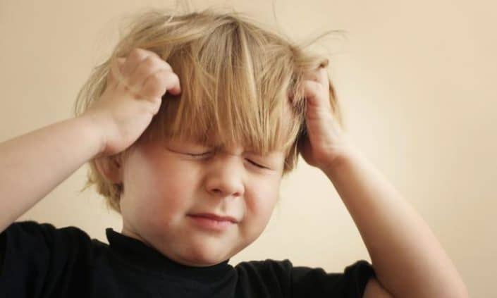 little boy itching head from head lice