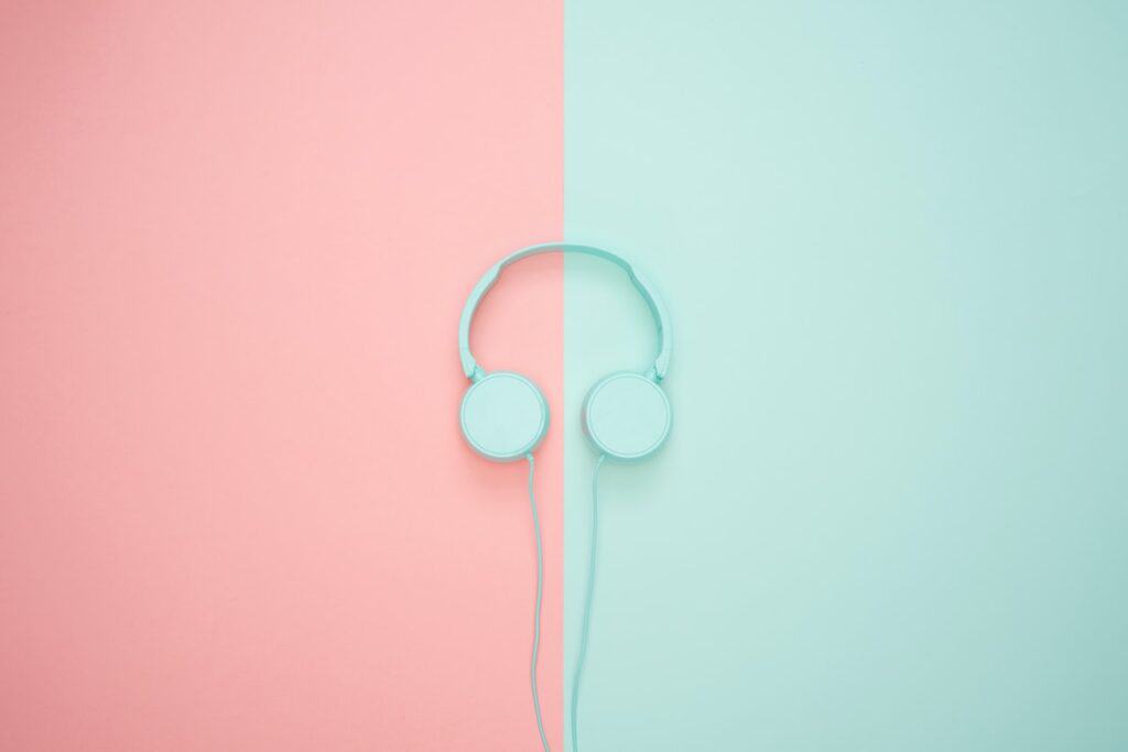 mint colored head phones on pink and mint background